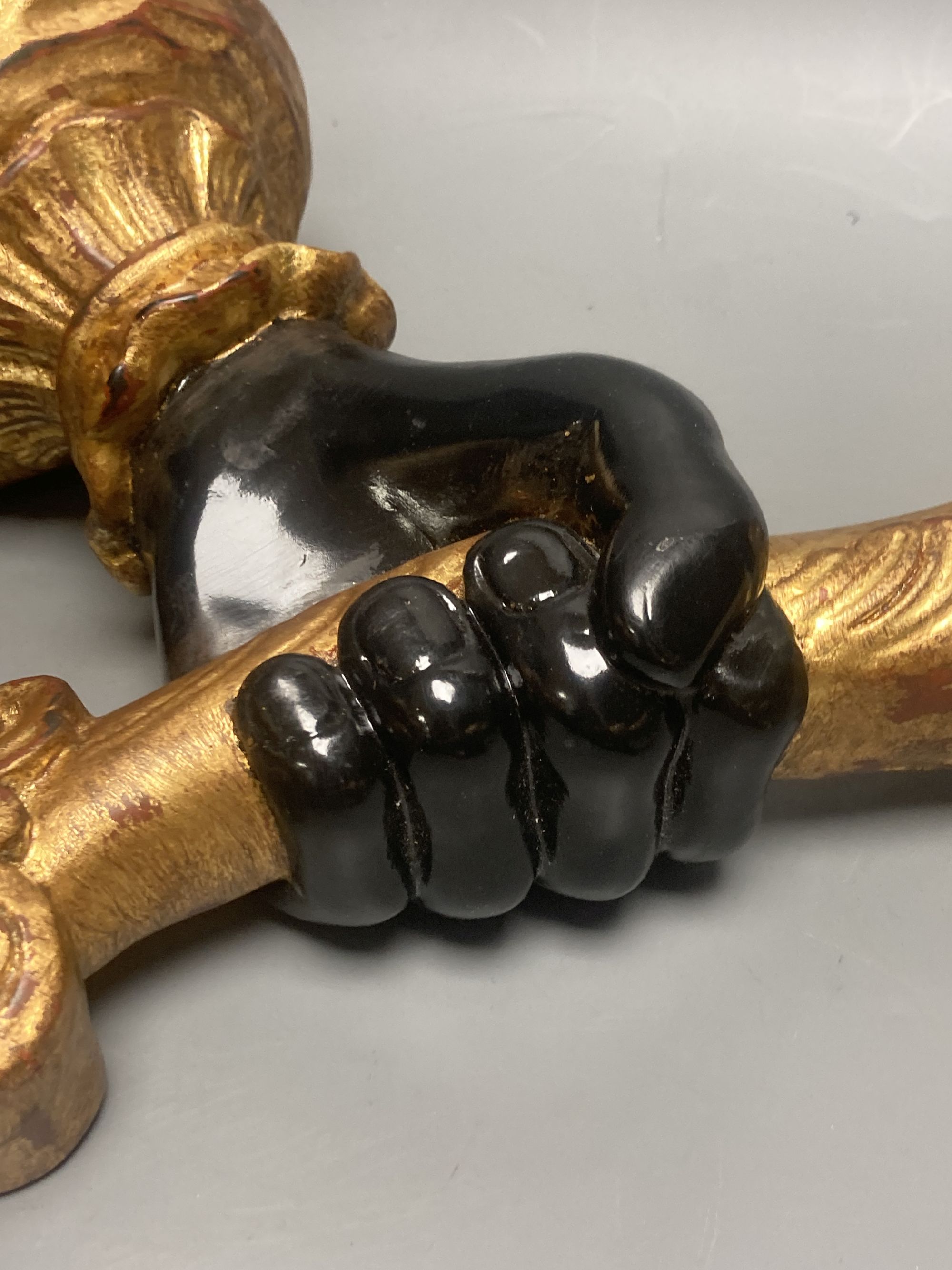 A pair of gilt and ebonised carved wood hand and cornucopia wall sconces, height 52cm not including light fitting